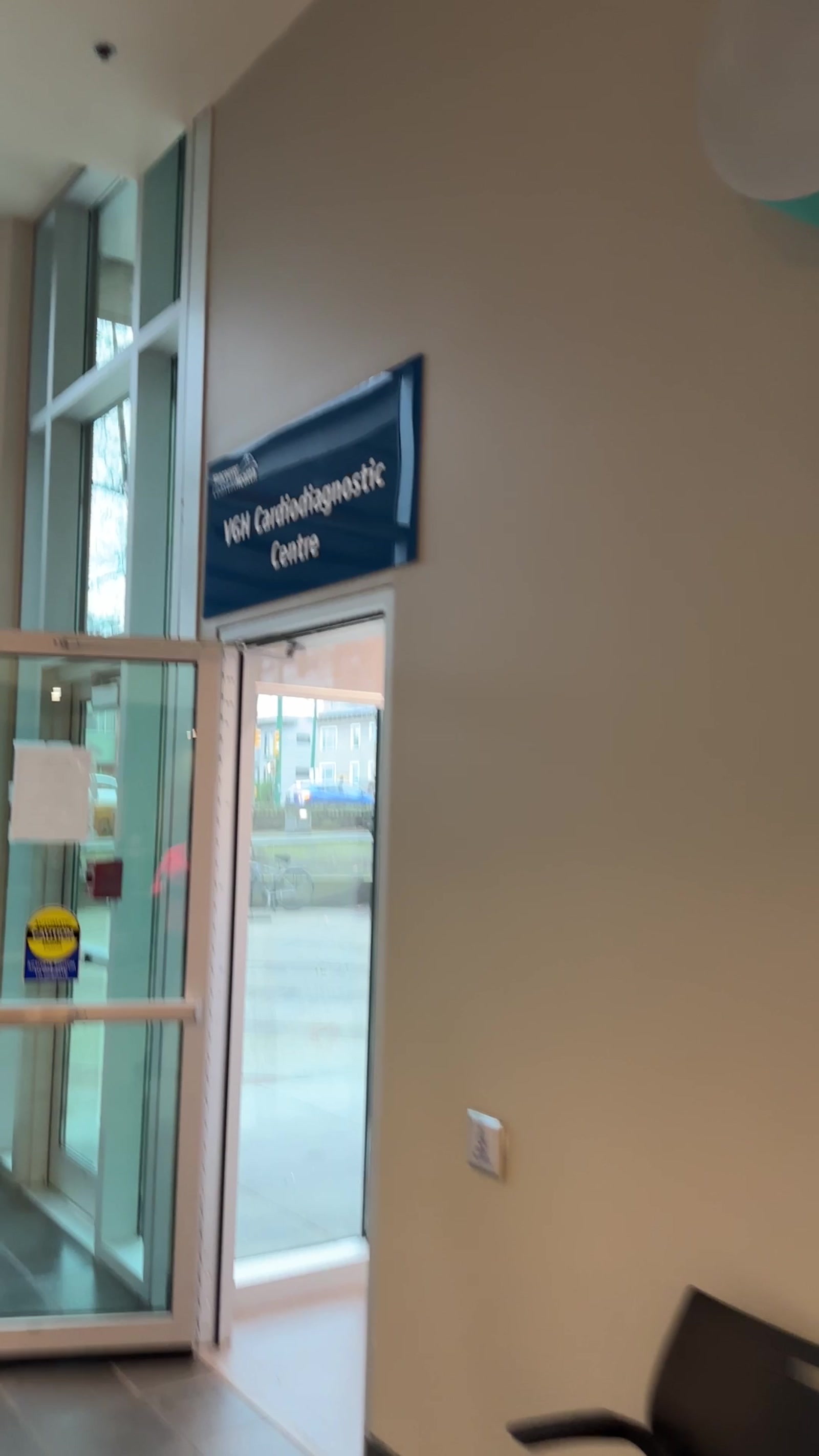 Cardiology clinic waiting room, empty chairs, frosted glass doors